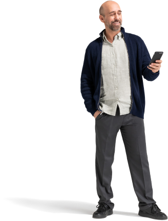 A man in a black jacket checks his smartphone.